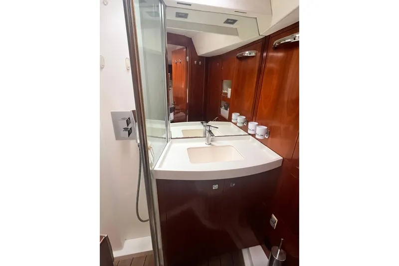  Yacht Photos Pics Luxurious bathroom in 2011 Amel 55 yacht with wooden cabinetry and modern fixtures.