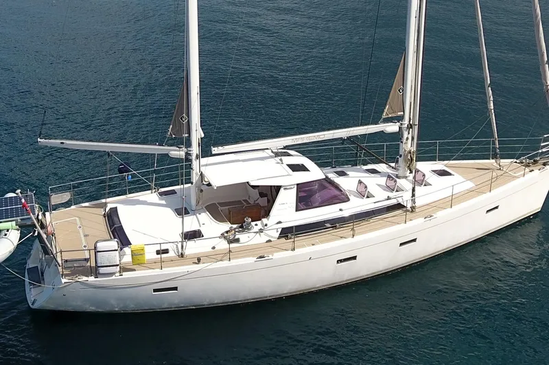  Yacht Photos Pics Sailing yacht Amel 55, 2011 model, anchored on calm blue waters.