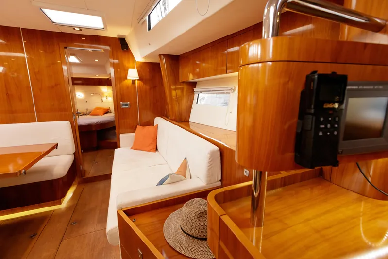  Yacht Photos Pics Luxurious interior of 2011 Amel 55 yacht with wooden finish and cozy seating area.