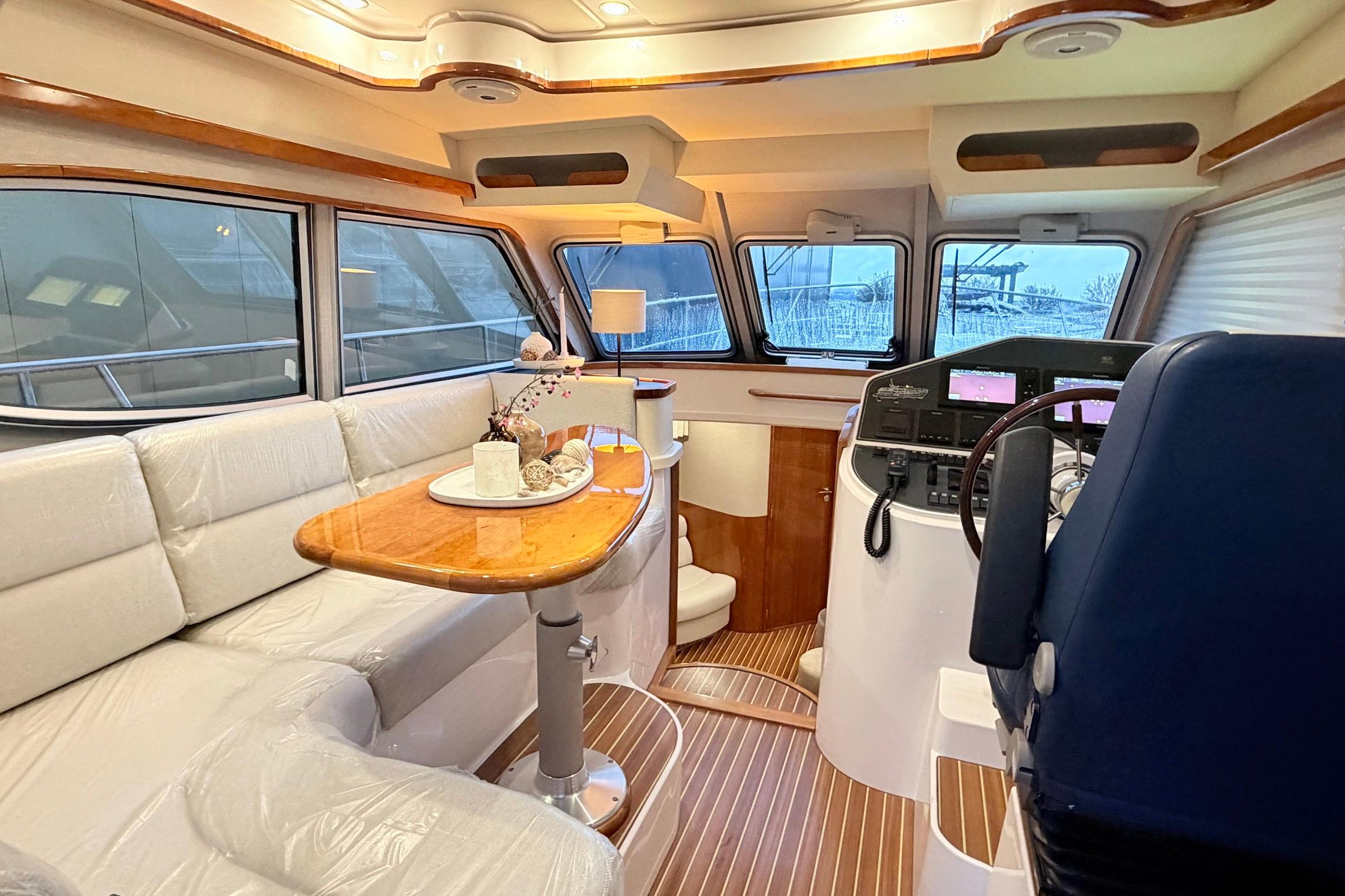 Luxurious interior of a 2017 Elling E4 yacht with elegant seating and navigation area.