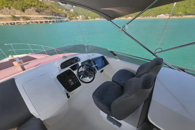  Yacht Photos Pics Luxurious 2017 Princess 52 yacht helm with dual seats, overlooking turquoise waters.