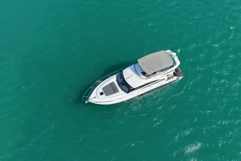 Yacht Photos Pics Aerial view of 2017 Princess 52 yacht cruising on turquoise waters.