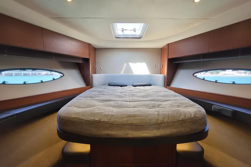  Yacht Photos Pics Luxurious interior of 2017 Princess 52 yacht with spacious bed and scenic windows.