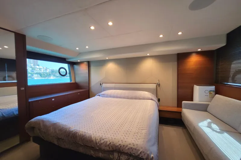  Yacht Photos Pics Luxurious bedroom interior on a 2017 Princess 52 yacht, featuring a cozy bed and elegant decor.