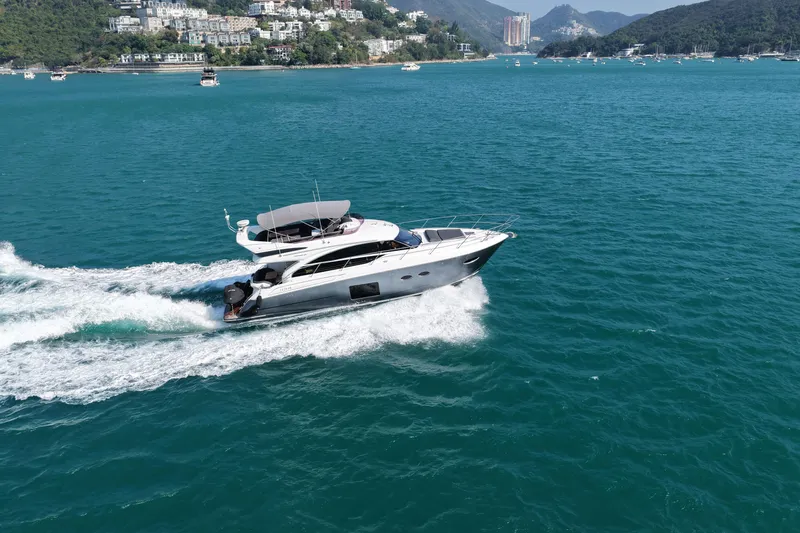  Yacht Photos Pics 2017 Princess 52 yacht cruising on blue ocean near scenic coastline.