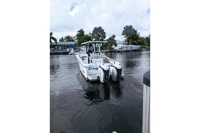  Yacht Photos Pics 2020 Blackfin 272 CC boat on a calm waterway, featuring dual outboard engines.
