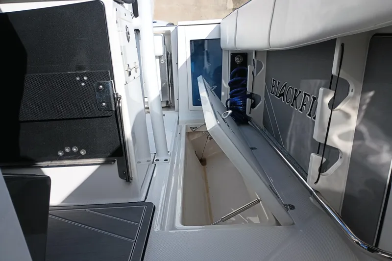  Yacht Photos Pics 2020 Blackfin 272 CC boat interior with open storage compartment and seating area.