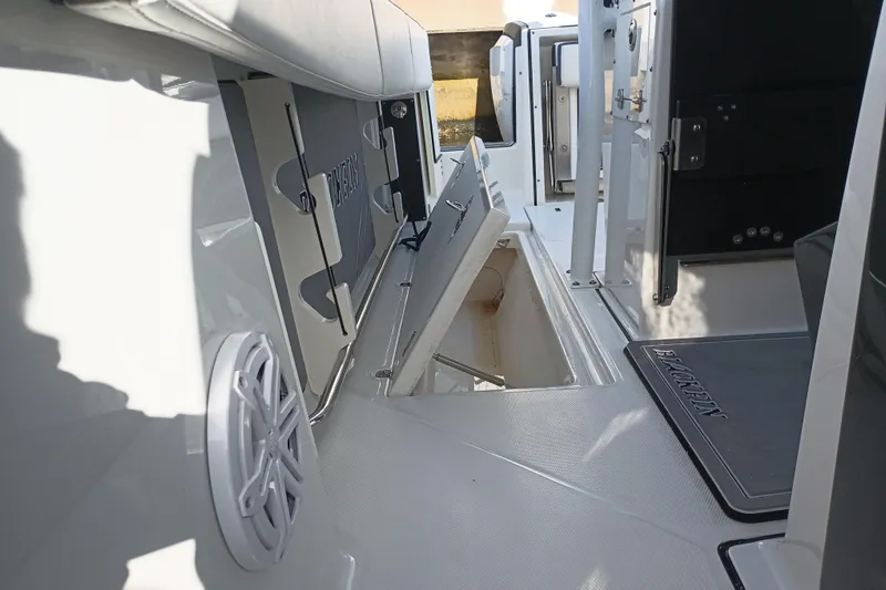  Yacht Photos Pics 2020 Blackfin 272 CC boat interior with open storage compartment and speaker.