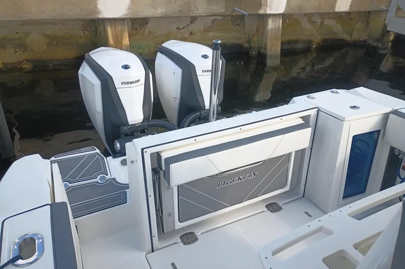  Yacht Photos Pics 2020 Blackfin 272 CC boat with dual Evinrude engines docked.