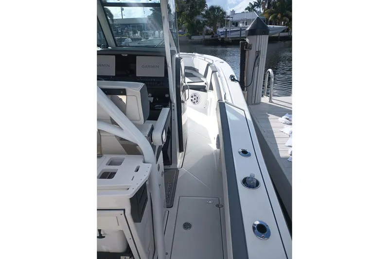 Yacht Photos Pics 2020 Blackfin 272 CC boat interior with Garmin displays, docked by the water.