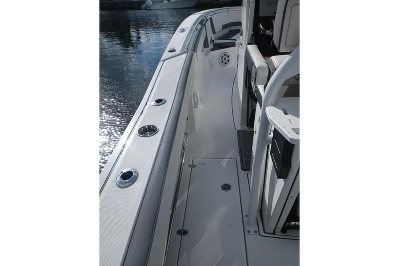  Yacht Photos Pics 2020 Blackfin 272 CC boat deck with rod holders and seating, docked by water.