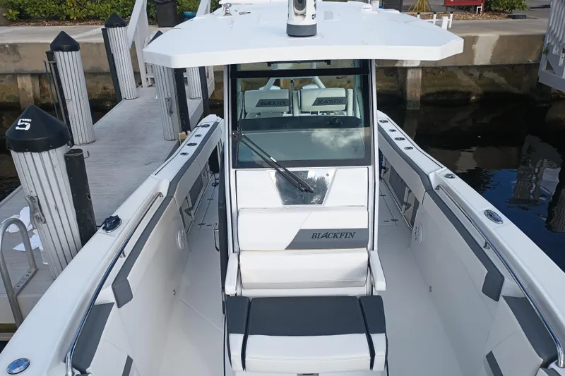  Yacht Photos Pics 2020 Blackfin 272 CC boat docked, showcasing sleek design and spacious deck.