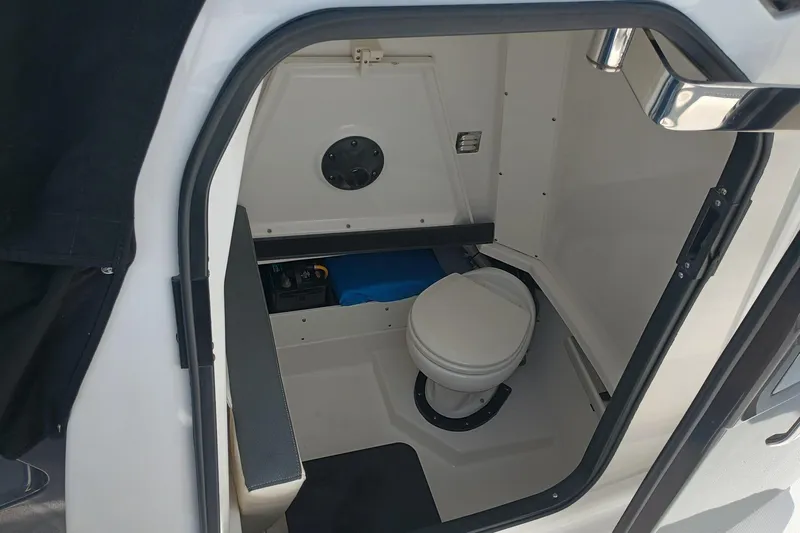  Yacht Photos Pics 2020 Blackfin 272 CC boat interior with compact marine toilet.