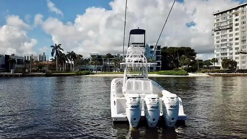 Troublemaker Yacht Photos Pics 2020 Invincible 39 Open Fisherman boat with triple engines on a calm waterway.