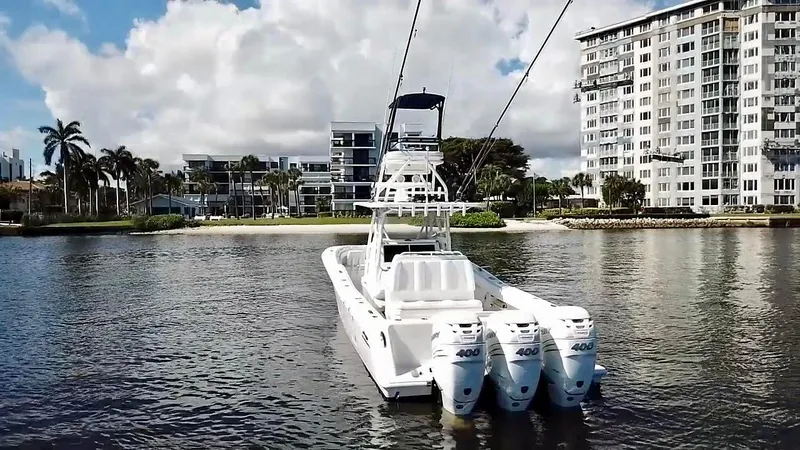 Troublemaker Yacht Photos Pics 2020 Invincible 39 Open Fisherman boat on water, with triple outboard engines.