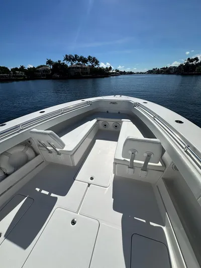Troublemaker Yacht Photos Pics 2020 Invincible 39 Open Fisherman boat on calm water, sunny day.