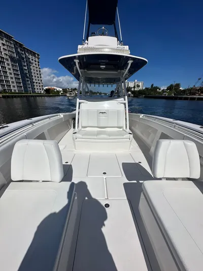 Troublemaker Yacht Photos Pics 2020 Invincible 39 Open Fisherman boat on calm water, clear sky background.