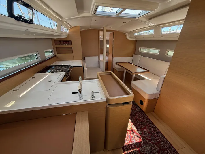 Ceci Yacht Photos Pics Interior of 2021 Jeanneau Sun Odyssey 410 yacht, featuring modern kitchen and dining area.