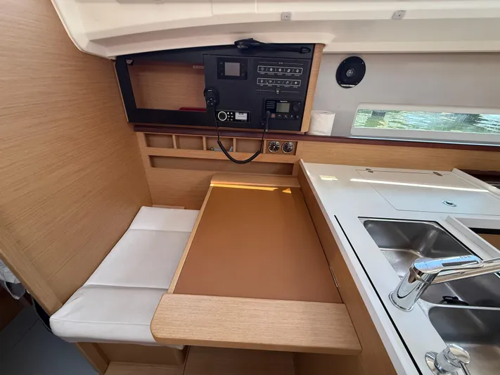 Ceci Yacht Photos Pics Interior of 2021 Jeanneau Sun Odyssey 410 yacht, featuring a compact kitchen and seating area.