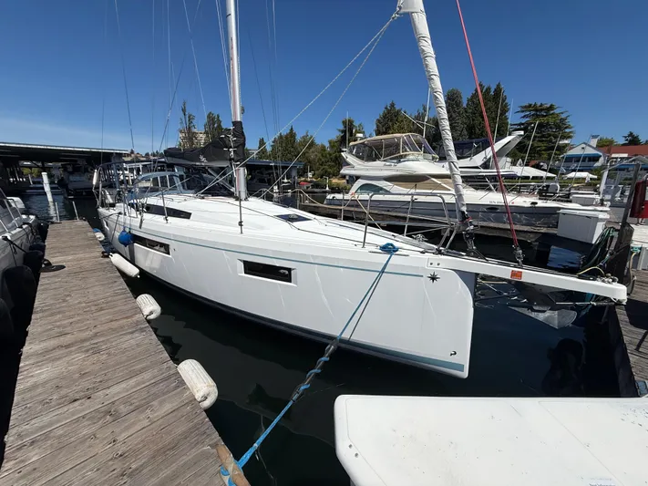 Ceci Yacht Photos Pics 2021 Jeanneau Sun Odyssey 410 sailboat docked at marina under clear blue sky.