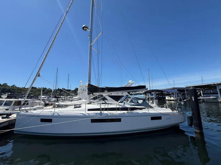 Ceci Yacht Photos Pics 2021 Jeanneau Sun Odyssey 410 sailboat docked at marina under clear blue sky.