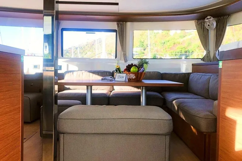 Spanky's Gang Yacht Photos Pics Luxurious interior of 2021 Lagoon 46 catamaran with cozy seating and dining area.