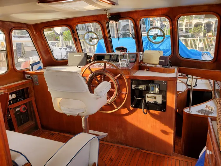  Yacht Photos Pics Interior of 1982 Cheoy Lee 52 yacht with wooden helm and navigation equipment.