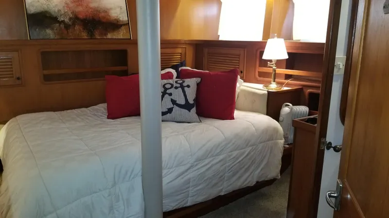  Yacht Photos Pics Cozy bedroom interior of 1982 Cheoy Lee 52 yacht with nautical-themed decor.