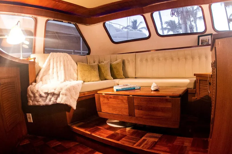  Yacht Photos Pics Luxurious interior of 1982 Cheoy Lee 52 yacht with cozy seating and elegant wood finish.