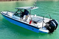 2020 Axopar 28 T-Top boat on clear turquoise water, featuring sleek design and dual engines.