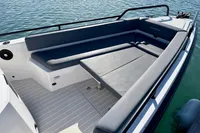 2020 Axopar 28 T-Top boat with spacious seating area on calm water.