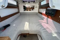 Interior cabin of 2020 Axopar 28 T-Top with gray upholstery and control panel.
