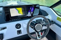2020 Axopar 28 T-Top boat dashboard with navigation screens and steering wheel.
