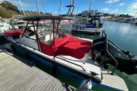 2020 Axopar 28 T-Top boat docked in a marina with red canopy.