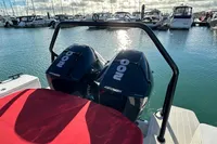 2020 Axopar 28 T-Top with twin Mercury 200 engines docked in marina.