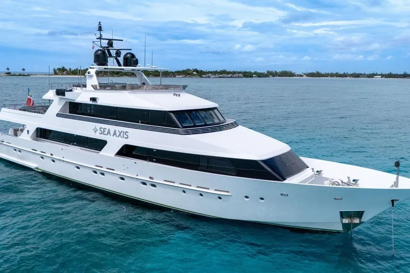 Sea Axis Yacht Photos Pics Luxury 1988 Heesen Trideck yacht "Sea Axis" cruising in clear blue waters.