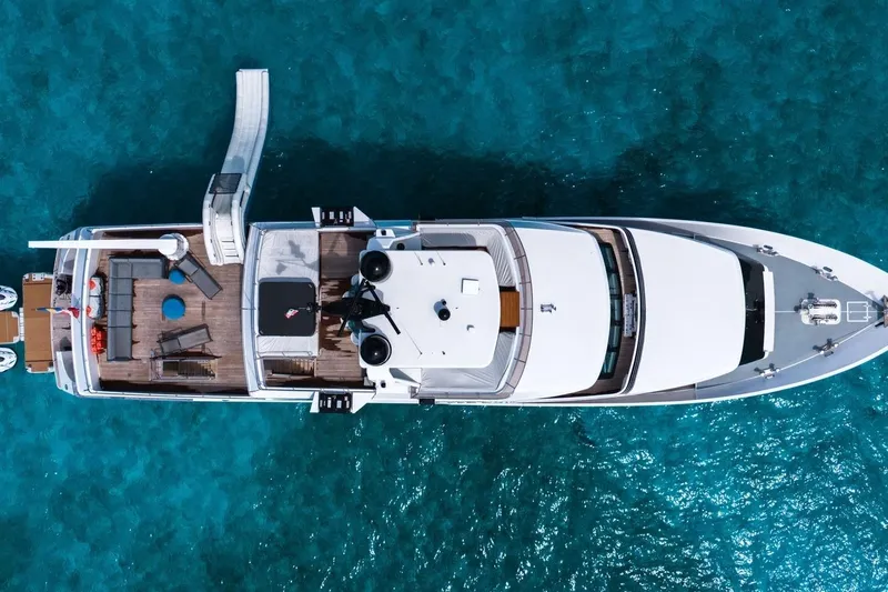 Sea Axis Yacht Photos Pics Aerial view of 1988 Heesen Trideck yacht on clear blue water.