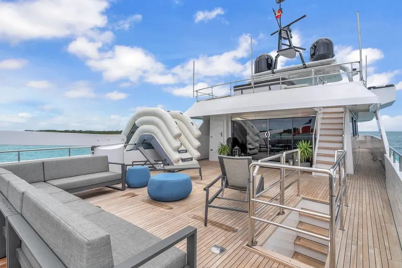 Sea Axis Yacht Photos Pics Luxurious 1988 Heesen Trideck yacht deck with modern seating and ocean view.