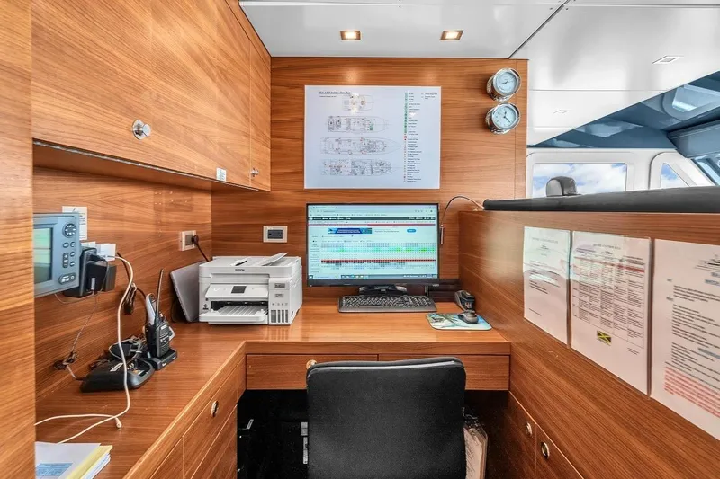 Sea Axis Yacht Photos Pics Heesen Trideck 1988 yacht office with wooden interior, computer, and printer setup.
