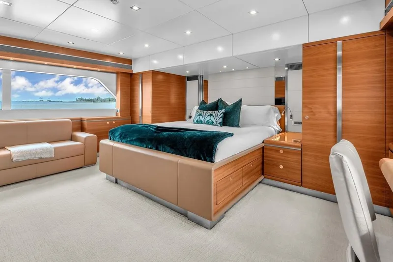 Sea Axis Yacht Photos Pics Luxurious bedroom interior on 1988 Heesen Trideck yacht with ocean view and elegant furnishings.