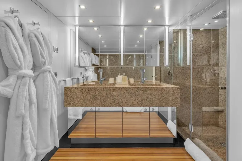 Sea Axis Yacht Photos Pics Luxurious yacht bathroom with marble sink, glass shower, and plush robes on Heesen Trideck 1988.