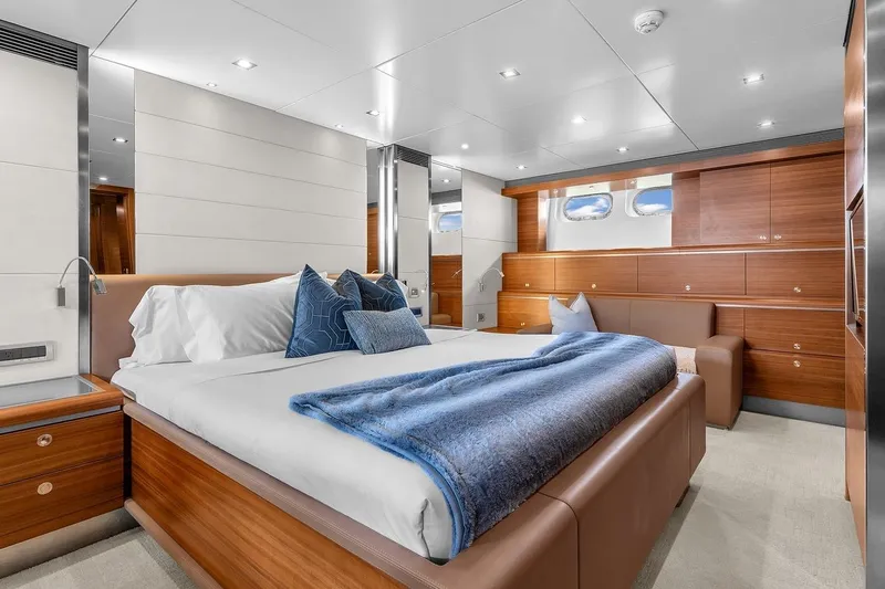 Sea Axis Yacht Photos Pics Luxurious bedroom interior on 1988 Heesen Trideck yacht, featuring elegant wood paneling and modern design.