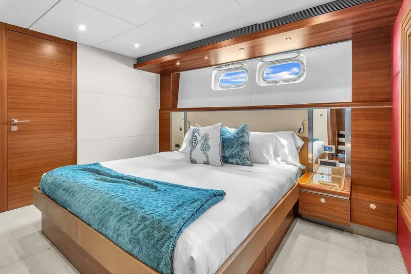 Sea Axis Yacht Photos Pics Luxurious bedroom interior on 1988 Heesen Trideck yacht with elegant wood finishes.