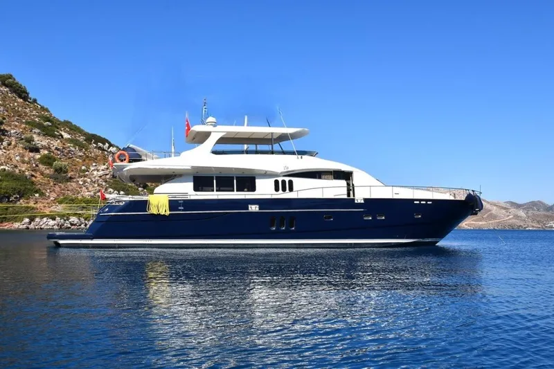  Yacht Photos Pics Luxury Princess 25M yacht from 2005 on serene blue waters, clear sky backdrop.