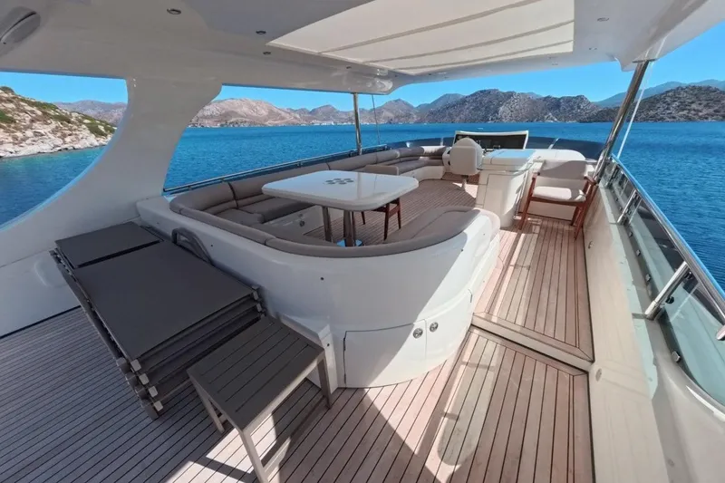 Yacht Photos Pics Luxurious 2005 Princess 25M yacht deck with seating, overlooking scenic blue waters and mountains.