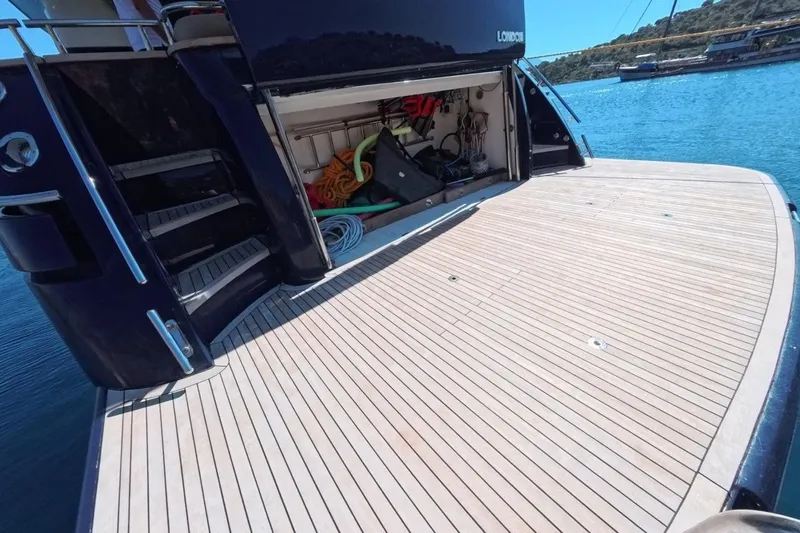  Yacht Photos Pics Luxury yacht Princess 25M, 2005 model, with open storage and teak deck by the water.