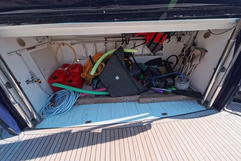  Yacht Photos Pics Storage compartment of a 2005 Princess 25M boat with various equipment and supplies.