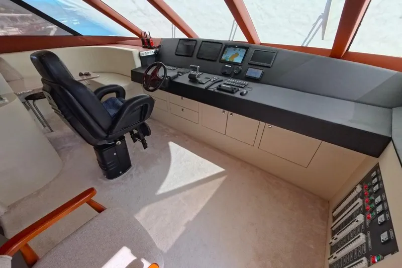  Yacht Photos Pics Control room of a 2005 Princess 25M yacht with navigation equipment and captain's chair.