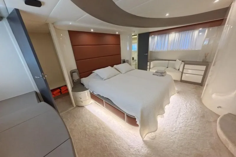  Yacht Photos Pics Luxurious bedroom interior of 2005 Princess 25M yacht with modern design and cozy ambiance.