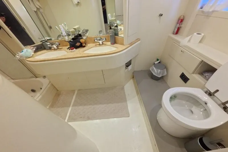  Yacht Photos Pics Luxury yacht bathroom with dual sinks, toilet, and shower in a 2005 Princess 25M model.